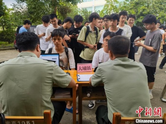 專武干部在發(fā)放兵役登記證。韋碩 攝