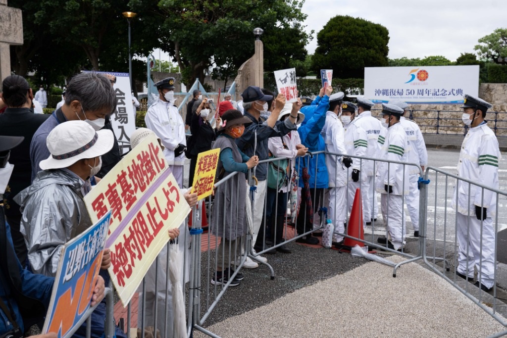 2022年5月15日，在日本沖繩，人們在沖繩回歸日本本土50周年紀念儀式現(xiàn)場外抗議。新華社記者張笑宇攝
