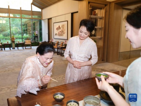 7月27日下午，國家主席習(xí)近平夫人彭麗媛在四川成都會(huì)見陪同印度尼西亞總統(tǒng)佐科來華出席第31屆世界大學(xué)生夏季運(yùn)動(dòng)會(huì)開幕式并訪華的總統(tǒng)夫人伊莉亞娜。這是彭麗媛邀請伊莉亞娜觀看茶藝表演，并同伊莉亞娜親切茶敘。新華社記者 丁林 攝