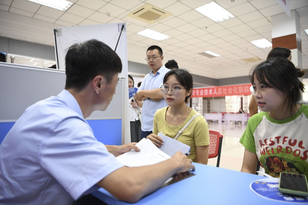2023年7月29日，“揚(yáng)就業(yè)之帆，啟夢(mèng)想之旅”2023年寧夏（銀川）離校未就業(yè)高校畢業(yè)生招聘會(huì)在寧夏（銀川）人力資源服務(wù)產(chǎn)業(yè)園舉行。求職者（右）在招聘會(huì)現(xiàn)場(chǎng)與用人單位交流。新華社記者 馮開(kāi)華 攝