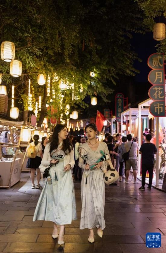 在成都寬窄巷子，兩位來(lái)自安徽的游客在新“十二月市”街區(qū)游覽（9月29日攝）。
