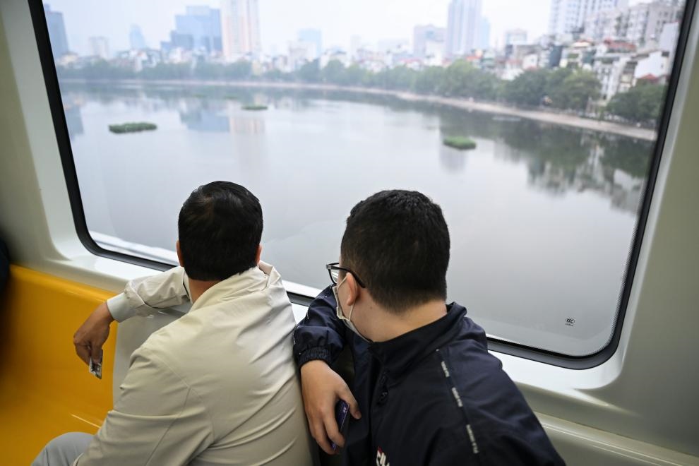 12月9日，市民在越南河內(nèi)輕軌二號線車廂內(nèi)透過車窗欣賞城市風(fēng)景。
