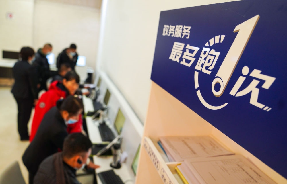 在吉林省長(zhǎng)春市二道區(qū)政務(wù)服務(wù)中心輔助填報(bào)區(qū)，市民在工作人員的輔助下進(jìn)行事項(xiàng)填報(bào)（2020年11月23日攝）。新華社記者 許暢 攝