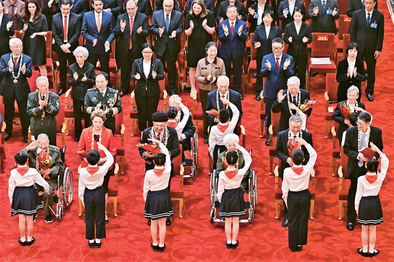 2024年9月29日，中華人民共和國(guó)國(guó)家勛章和國(guó)家榮譽(yù)稱號(hào)頒授儀式在北京人民大會(huì)堂隆重舉行。圖為少先隊(duì)員向國(guó)家勛章和國(guó)家榮譽(yù)稱號(hào)獲得者敬禮致意。 新華社記者 岳月偉/攝