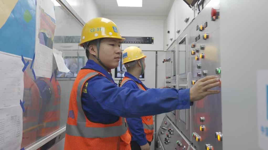 盾構(gòu)司機(jī)何曉波在駕駛室內(nèi)調(diào)試盾構(gòu)機(jī)參數(shù)。（劉芬攝）