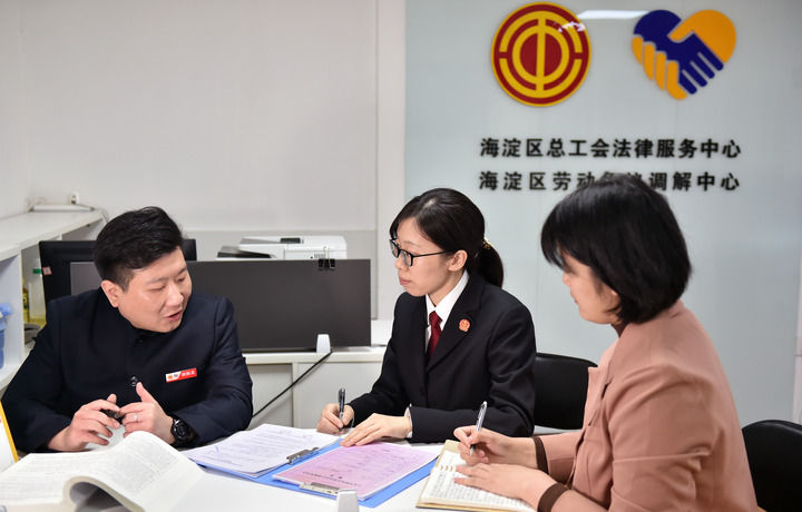 2025年3月6日，在北京市海淀區(qū)總工會勞動爭議調(diào)解中心，海淀區(qū)人民法院法官王琰（中）與該中心工作人員就糾紛化解情況進行溝通。新華社記者 趙婷婷 攝